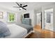 Inviting bedroom with hardwood floors, ceiling fan, and ensuite bathroom at 1104 Warrenhall Ne Ln, Brookhaven, GA 30319