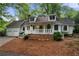 Charming home featuring a welcoming front porch and well-maintained landscaping at 1104 Warrenhall Ne Ln, Brookhaven, GA 30319
