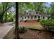 Charming home featuring a welcoming front porch and wooded lot at 1104 Warrenhall Ne Ln, Brookhaven, GA 30319