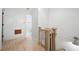Hallway with wood floors and white walls leads to a bathroom at 1104 Warrenhall Ne Ln, Brookhaven, GA 30319