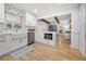 Bright modern kitchen featuring white cabinetry, hardwood floors, and stainless appliances at 1104 Warrenhall Ne Ln, Brookhaven, GA 30319