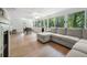 Spacious sunroom with large windows and a comfortable sectional sofa at 1104 Warrenhall Ne Ln, Brookhaven, GA 30319