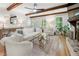 Bright living room with hardwood floors, fireplace, and ceiling beams at 1104 Warrenhall Ne Ln, Brookhaven, GA 30319