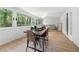Bright sun room with large windows, dining table and comfortable seating area at 1104 Warrenhall Ne Ln, Brookhaven, GA 30319