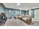 Finished basement featuring a drop ceiling, a large sectional, and beige walls at 3271 Sutcliffe Nw Rdg, Marietta, GA 30064