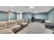 Finished basement featuring a drop ceiling, a large gray sectional, and beige walls at 3271 Sutcliffe Nw Rdg, Marietta, GA 30064