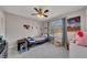 Bedroom featuring a ceiling fan, a patterned curtain, a window with a view, and Star Wars art at 3271 Sutcliffe Nw Rdg, Marietta, GA 30064