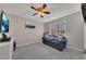 Cozy bedroom with a ceiling fan, a blue couch, a window with a view, and natural light at 3271 Sutcliffe Nw Rdg, Marietta, GA 30064