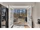 View of a wooden deck through the kitchen doors, featuring seating and a grill at 3271 Sutcliffe Nw Rdg, Marietta, GA 30064