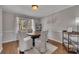Cozy dining room features a round table, white chairs, decorative rug, and soft natural light at 3271 Sutcliffe Nw Rdg, Marietta, GA 30064