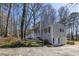 Exterior view of home with attached garage, driveway, and spacious front yard with mature trees at 3271 Sutcliffe Nw Rdg, Marietta, GA 30064