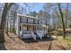 Attractive two-story home featuring a covered front porch and set amidst a serene, wooded landscape, offering privacy at 3271 Sutcliffe Nw Rdg, Marietta, GA 30064