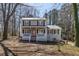 Charming two-story home with a welcoming front porch and neatly maintained front yard surrounded by mature trees at 3271 Sutcliffe Nw Rdg, Marietta, GA 30064