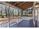 Cozy covered front porch featuring a bistro table set perfect for enjoying the tranquil, wooded surroundings at 3271 Sutcliffe Nw Rdg, Marietta, GA 30064