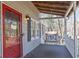 Quaint covered porch with a comfortable swing, offering a relaxing outdoor space with views of the peaceful neighborhood at 3271 Sutcliffe Nw Rdg, Marietta, GA 30064