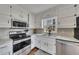 A close up of the kitchen's appliances and white countertops, cabinetry, and tile backsplash at 3271 Sutcliffe Nw Rdg, Marietta, GA 30064
