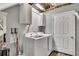 Functional laundry room with modern washer and dryer, storage cabinets, and a convenient layout at 3271 Sutcliffe Nw Rdg, Marietta, GA 30064