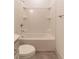 Bright bathroom featuring a shower-tub combo with white tile surround and chrome fixtures at 429 Stovall Pl, Woodstock, GA 30188