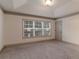 Neutral bedroom with large window and crown molding at 429 Stovall Pl, Woodstock, GA 30188