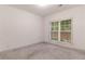 Empty bedroom with a large window bringing in natural light at 429 Stovall Pl, Woodstock, GA 30188