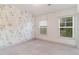 Comfortable bedroom with natural light from two windows and floral-themed wallpaper at 429 Stovall Pl, Woodstock, GA 30188