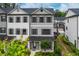 Charming three-story townhouse with gray siding and a well-manicured front yard at 429 Stovall Pl, Woodstock, GA 30188