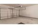 Spacious two car garage featuring concrete flooring and an automatic garage door at 429 Stovall Pl, Woodstock, GA 30188