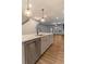 Modern kitchen with stainless steel appliances and hardwood floors leading to the living room at 429 Stovall Pl, Woodstock, GA 30188