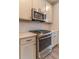 Close-up of the stainless steel range and oven in a stylish, modern kitchen at 429 Stovall Pl, Woodstock, GA 30188