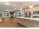 Open-concept living area with fireplace, fan, hardwood floors, and contemporary finishes at 429 Stovall Pl, Woodstock, GA 30188