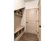 Mudroom with built-in bench and storage shelves, plus access to a closet at 429 Stovall Pl, Woodstock, GA 30188