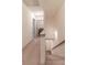 Carpeted staircase leading to a hallway and laundry room upstairs at 429 Stovall Pl, Woodstock, GA 30188