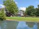 Spacious backyard with a tranquil pond, lush greenery, and a wooden fence at 514 Augusta Dr, Canton, GA 30115
