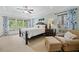 Comfortable bedroom featuring a trey ceiling, large windows, and stylish décor at 514 Augusta Dr, Canton, GA 30115
