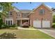 Charming two-story brick home featuring a manicured lawn and attached two-car garage at 514 Augusta Dr, Canton, GA 30115