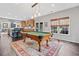 Spacious room with hardwood floors, featuring a pool table and access to the kitchen at 514 Augusta Dr, Canton, GA 30115