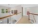 Bright hallway featuring white wooden rails, chandelier, and large windows at 514 Augusta Dr, Canton, GA 30115