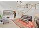 Bright living room with high ceilings, a staircase, and comfortable leather furniture at 514 Augusta Dr, Canton, GA 30115