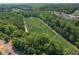 Aerial view of community soccer fields surrounded by lush green trees and houses at 6004 Turfway Park Ct, Sugar Hill, GA 30518