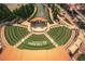 Aerial view of an outdoor amphitheater with tiered seating, a covered stage, and manicured landscaping, perfect for events at 6004 Turfway Park Ct, Sugar Hill, GA 30518