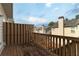 View from the wooden deck featuring railings and the rooftops of nearby townhomes at 6004 Turfway Park Ct, Sugar Hill, GA 30518