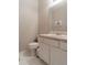 Modest bathroom featuring a white toilet and vanity with a white countertop and a mirror at 6004 Turfway Park Ct, Sugar Hill, GA 30518