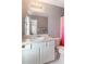Bright bathroom featuring a vanity with white cabinets, a mirror, and a toilet with a colorful shower curtain at 6004 Turfway Park Ct, Sugar Hill, GA 30518