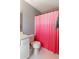 Bathroom featuring a vanity with white cabinets, a toilet and a pink-and-red ombre shower curtain at 6004 Turfway Park Ct, Sugar Hill, GA 30518
