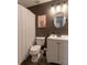 Bathroom with modern fixtures, including a vanity, mirror, and toilet, complemented by stylish decor at 6004 Turfway Park Ct, Sugar Hill, GA 30518