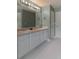 Spacious bathroom featuring double sinks, a large mirror, and ample storage space in a clean, modern design at 6004 Turfway Park Ct, Sugar Hill, GA 30518