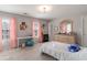 Cozy bedroom with two windows, soft natural light, a desk, dresser, and a comfortable bed at 6004 Turfway Park Ct, Sugar Hill, GA 30518
