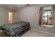 Bedroom with a simple bed frame, neutral walls, carpet, and natural light from the window at 6004 Turfway Park Ct, Sugar Hill, GA 30518