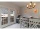 Bright dining area with natural light from a sliding door and white chairs around a dark wood table at 6004 Turfway Park Ct, Sugar Hill, GA 30518