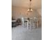 Cozy dining area features a chandelier over a wood and white table with seating for four on carpeted floors at 6004 Turfway Park Ct, Sugar Hill, GA 30518